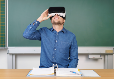 Enseignant devant un tableau noir avec un masque de réalité virtuelle